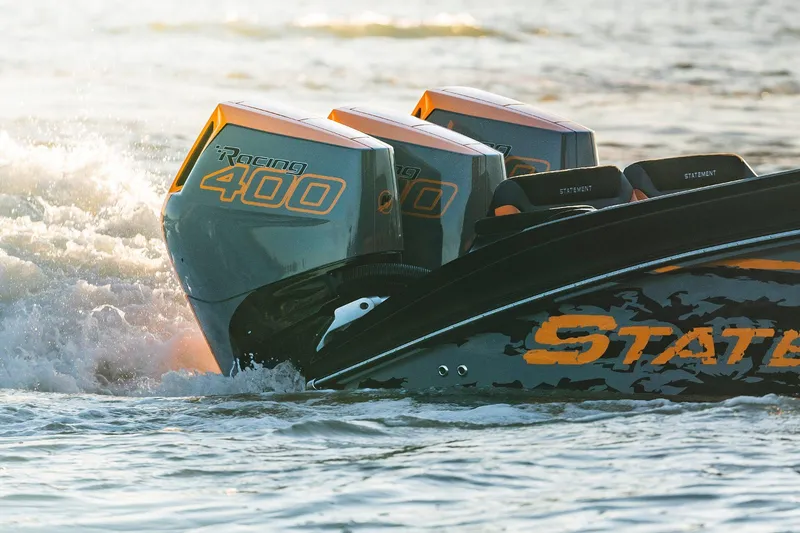 Slide: The Image of Triple Racing 400 engines on a 2026 Statement 35 CC Open boat in action. - 11