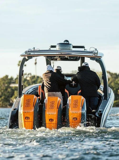 Slide: The Image of 2026 Statement 35 CC Open boat with triple 400 engines on water, rear view. - 14