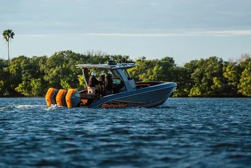 Slide: The Image of Statement 35 CC Open 2026 boat cruising on a lake with lush greenery in the background. - 15