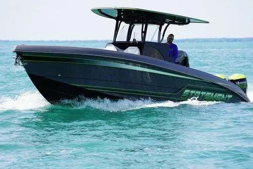 Slide: The Image of 2026 Statement 35 CC Open boat cruising on clear turquoise water. - 18