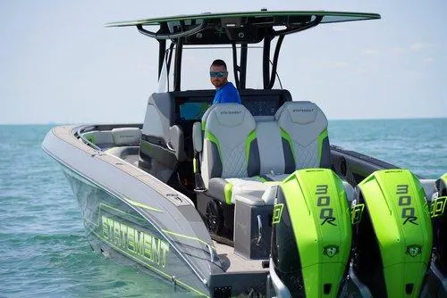 Slide: The Image of 2026 Statement 35 CC Open boat with dual 300R engines on the water. - 2