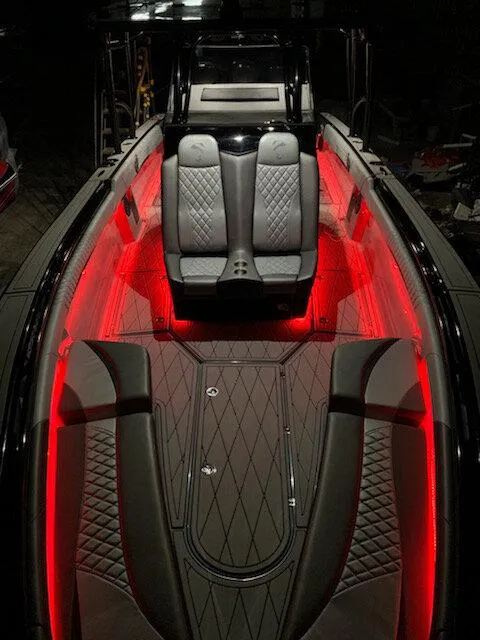 Slide: The Image of 2026 Statement 35 CC Open boat interior with red LED lighting and luxurious seating. - 21