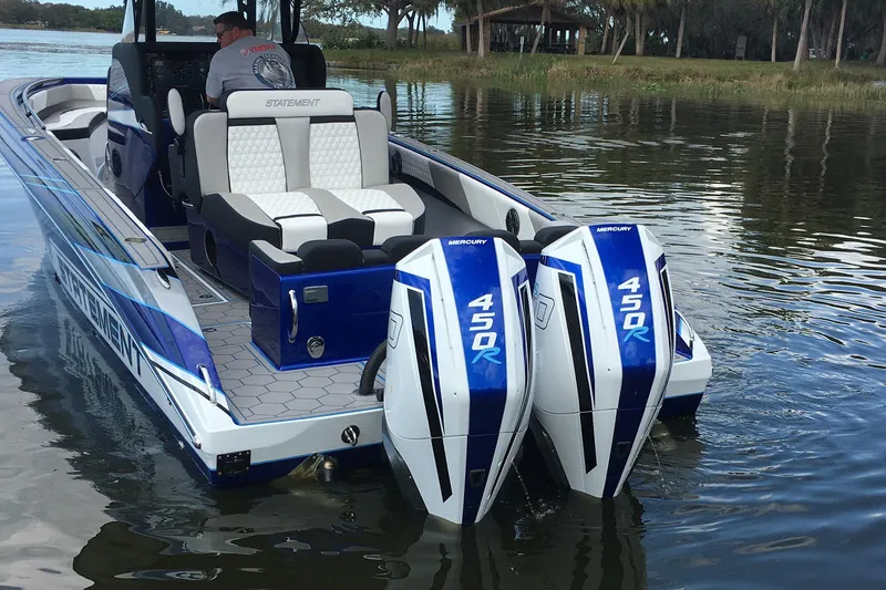 Slide: The Image of 2026 Statement 35 CC Open boat with dual Mercury 450R engines on a calm lake. - 22
