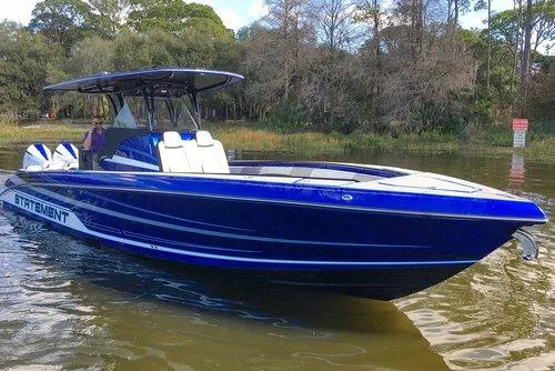 Slide: The Image of 2026 Statement 35 CC Open boat on water, featuring sleek blue design and spacious seating. - 23