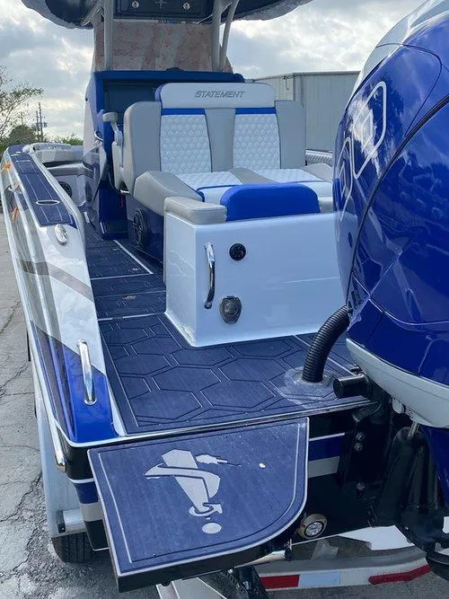 Slide: The Image of 2026 Statement 35 CC Open boat with blue and white seating, sleek design, and powerful engine. - 24