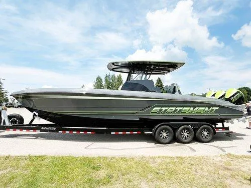 Slide: The Image of 2026 Statement 35 CC Open boat on trailer, sleek design, sunny day background. - 7
