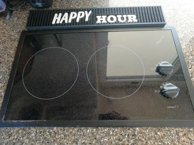 Slide: The Image of 2003 Meridian 341 Sedan kitchen with electric cooktop and 'Happy Hour' sign. - 12
