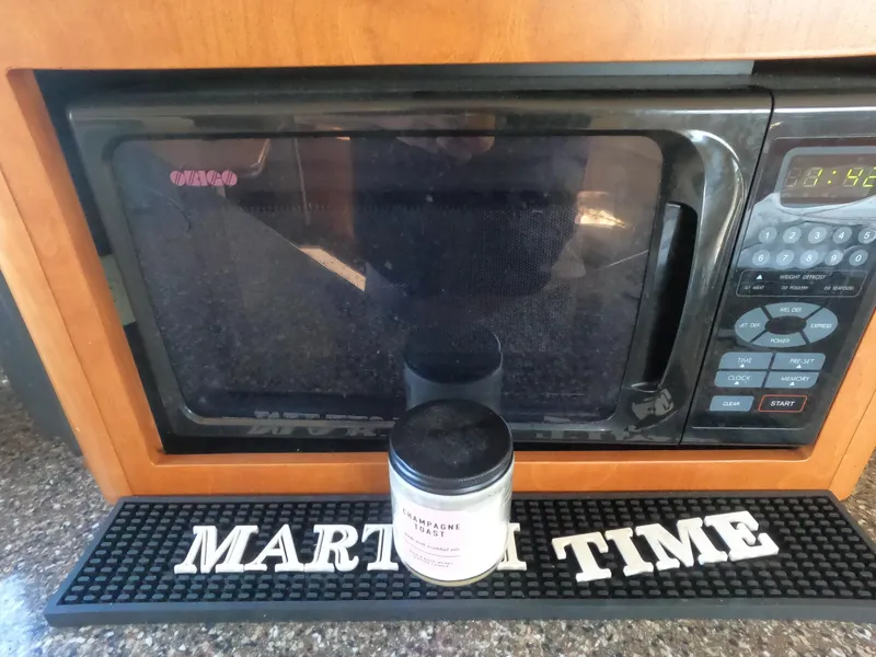 Slide: The Image of Microwave in a 2003 Meridian 341 Sedan with a Martini Time mat and a candle. - 13