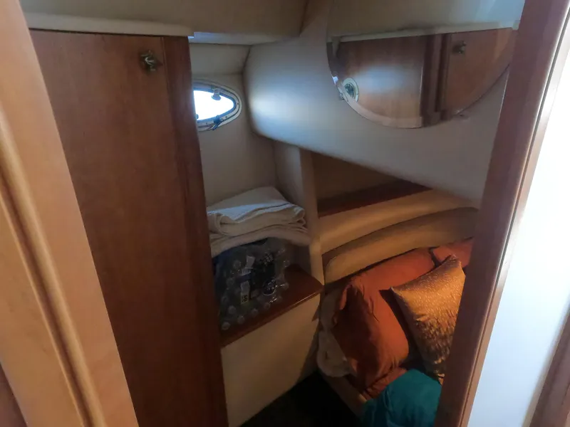 Slide: The Image of 2003 Meridian 341 Sedan cabin interior with bed, pillows, and storage space. - 22