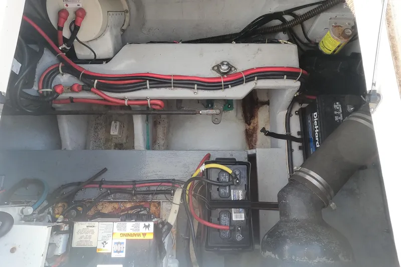 Slide: The Image of Engine compartment of a 2003 Meridian 341 Sedan with visible wiring and battery. - 28