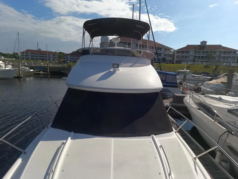 Slide: The Image of 2003 Meridian 341 Sedan yacht docked at marina with waterfront buildings in background. - 3