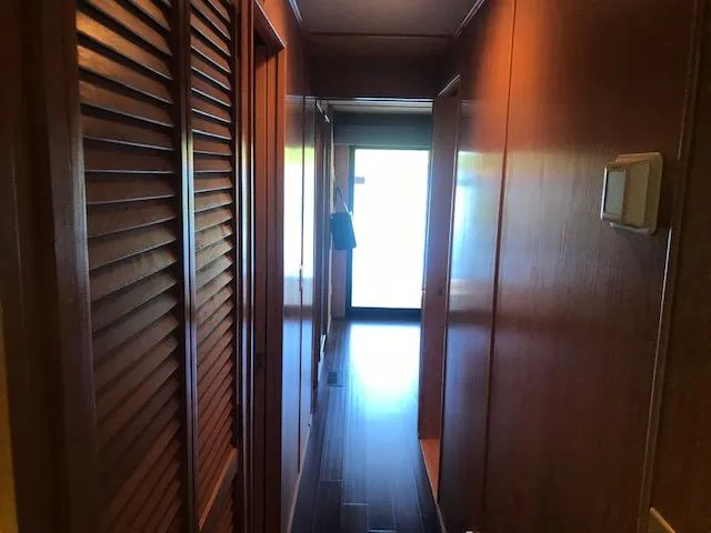Slide: The Image of Narrow wooden hallway inside a 1997 Stardust Cruisers houseboat, featuring sleek paneling. - 21