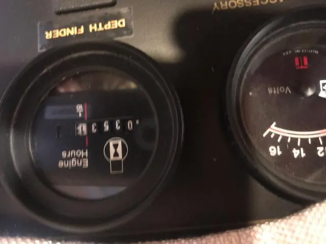 Slide: The Image of Close-up of 1997 Stardust Cruisers houseboat dashboard gauges, showing engine hours and voltage. - 25