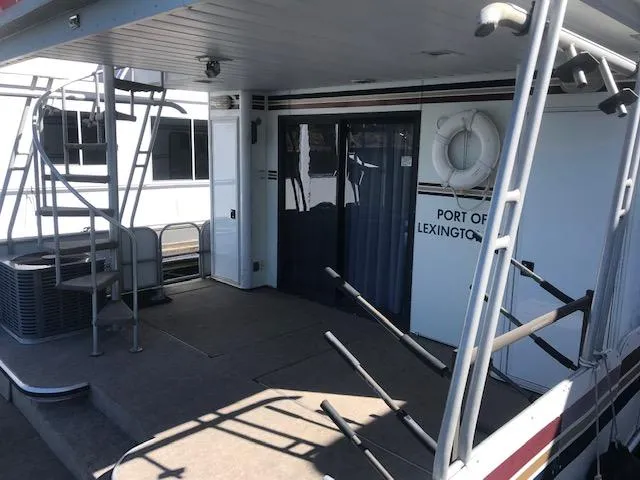 Slide: The Image of 1997 Stardust Cruisers houseboat deck with stairs and life preserver, Port of Lexington. - 26