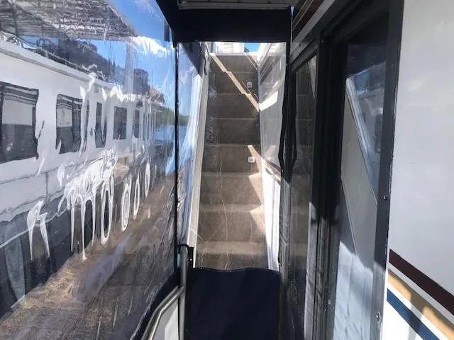 Slide: The Image of 1997 Stardust Cruisers houseboat with exterior stairs and clear protective covering. - 27