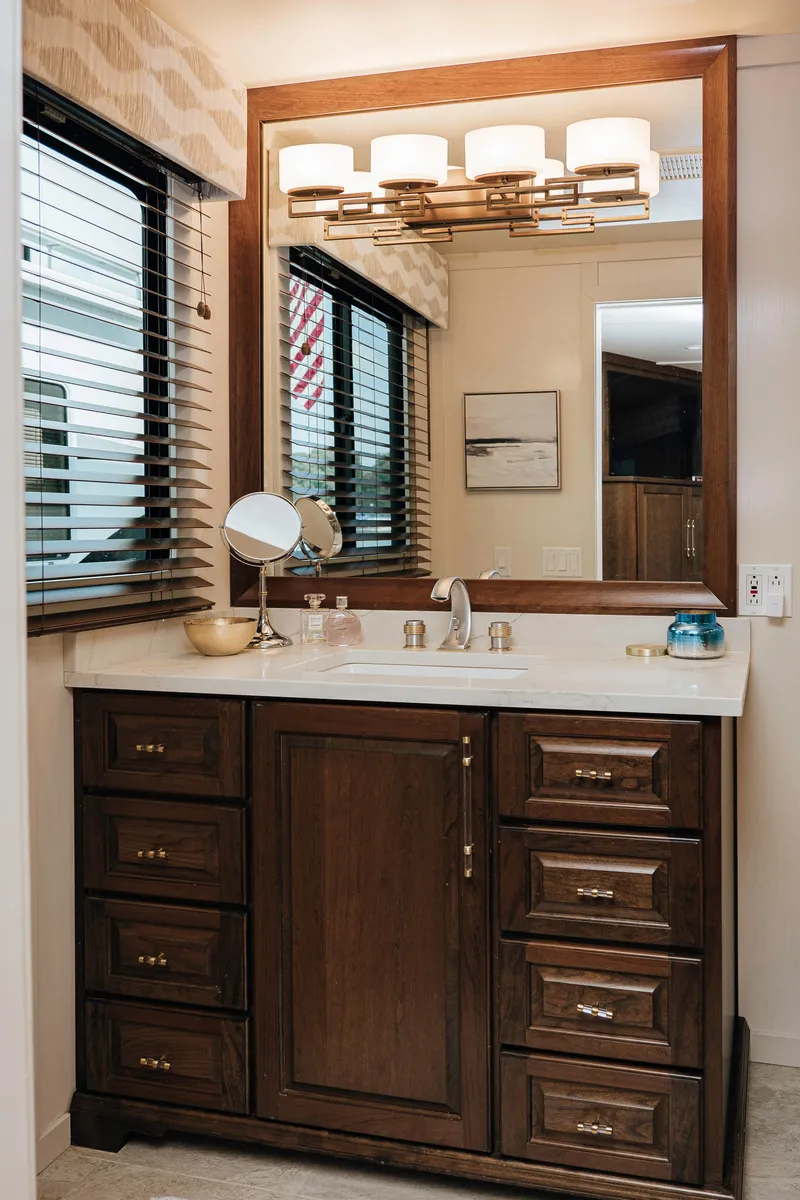 Slide: The Image of Luxurious bathroom vanity on a 1996 Sumerset Houseboat, featuring elegant wood cabinetry and modern lighting. - 15