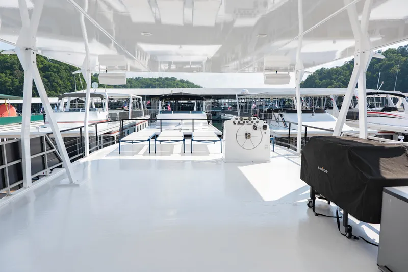 Slide: The Image of Spacious deck of 1996 Sumerset Houseboat, docked with scenic marina view. - 18