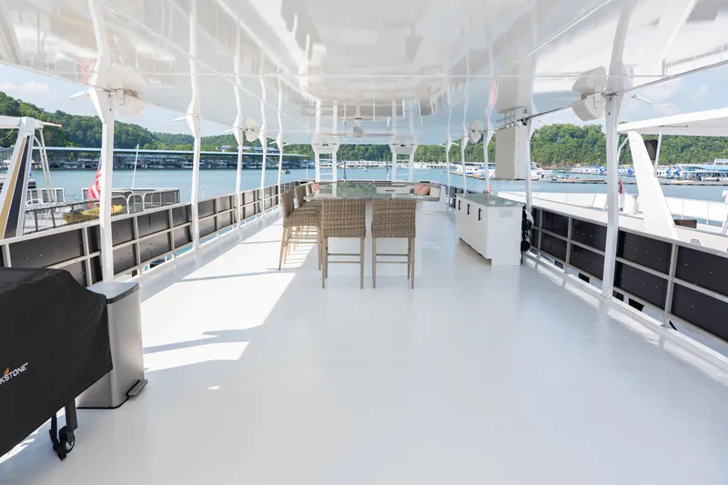 Slide: The Image of Spacious deck of 1996 Sumerset Houseboat, featuring outdoor seating and scenic lake views. - 19