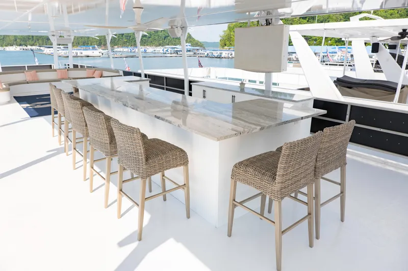 Slide: The Image of Luxurious 1996 Sumerset houseboat with outdoor bar and seating, docked at a scenic marina. - 20