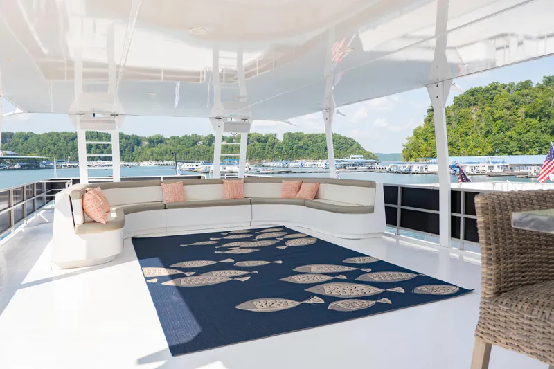 Slide: The Image of Spacious deck of 1996 Sumerset houseboat with seating and decorative rug, overlooking marina. - 21