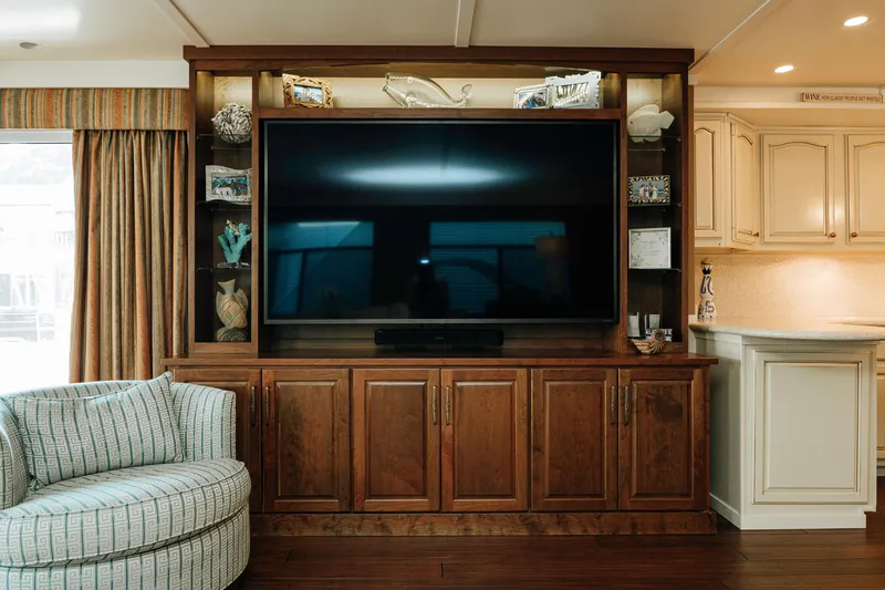 Slide: The Image of Luxurious 1996 Sumerset houseboat interior with large TV, wooden cabinetry, and cozy seating. - 4