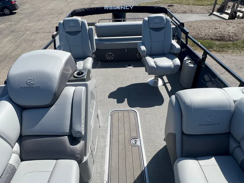 Slide: The Image of 2023 Regency 230 LE3 Sport pontoon boat interior with luxurious seating and modern design. - 3