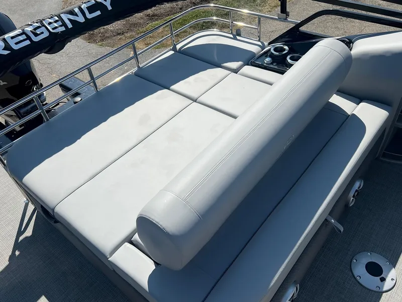 Slide: The Image of 2023 Regency 230 LE3 Sport boat with cushioned seating and cup holders. - 7