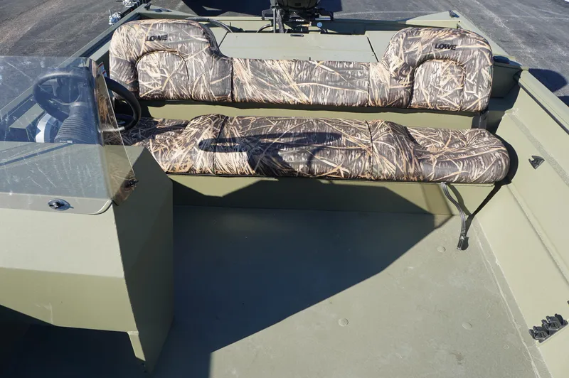 Slide: The Image of 2023 Lowe RX2070 SC boat interior with camouflage seating and steering console. - 11