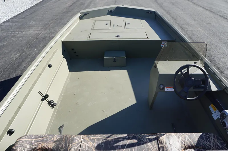 Slide: The Image of 2023 Lowe RX2070 SC fishing boat interior with steering console and storage compartments. - 5