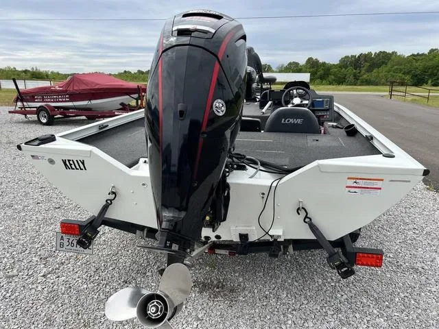 Slide: The Image of 2018 Lowe Stinger 188 boat rear view with outboard motor. - 11