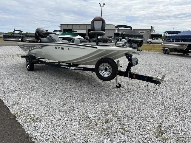 Slide: The Image of 2018 Lowe Stinger 188 fishing boat on a trailer in a gravel lot. - 3
