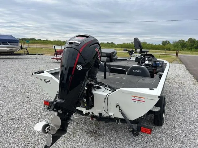 Slide: The Image of 2018 Lowe Stinger 188 boat with outboard motor on gravel lot. - 5