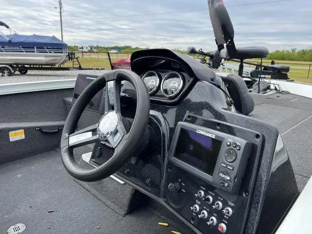 Slide: The Image of 2018 Lowe Stinger 188 boat dashboard with steering wheel and Lowrance fishfinder. - 6