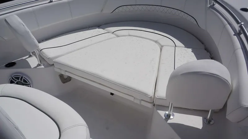 Slide: The Image of 2023 Sportsman 231 Heritage boat interior with white cushioned seating. - 14