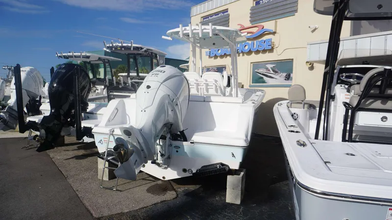 Slide: The Image of 2023 Sportsman 231 Heritage boat displayed at a dealership. - 19