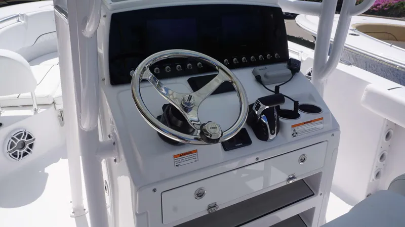 Slide: The Image of 2023 Sportsman 231 Heritage boat helm with steering wheel and control panel. - 4