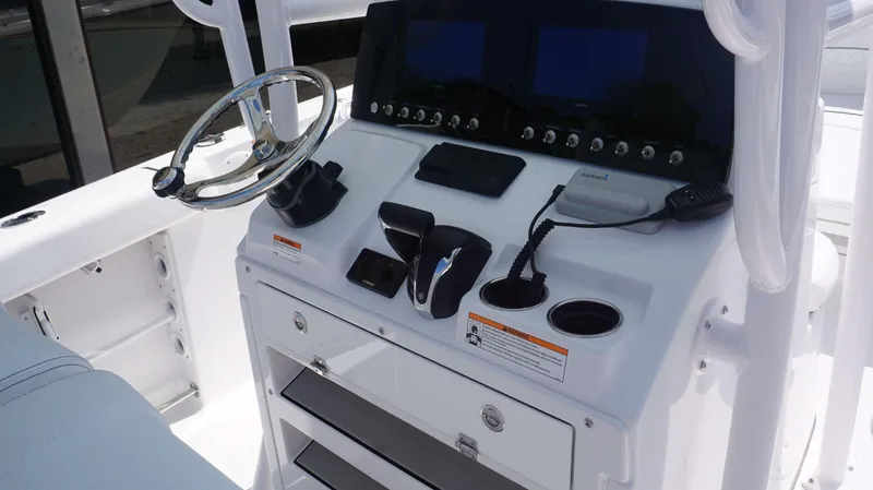 Slide: The Image of 2023 Sportsman 231 Heritage boat console with steering wheel, controls, and navigation screens. - 5