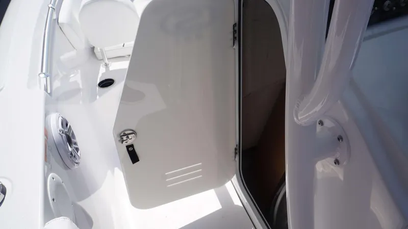 Slide: The Image of 2023 Sportsman 231 Heritage boat interior with open storage compartment and speaker. - 7