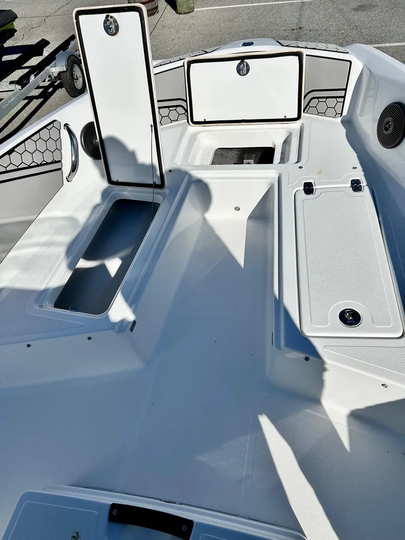Slide: The Image of 2020 Scarab 195 Open ID boat interior with open storage compartments. - 10