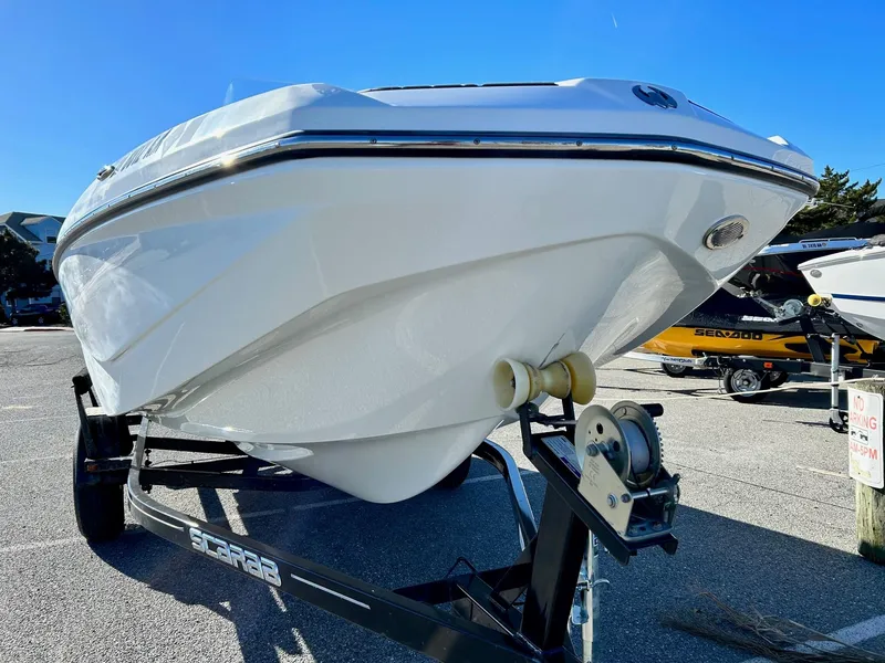 Slide: The Image of 2020 Scarab 195 Open ID boat on trailer, sunny day. - 2