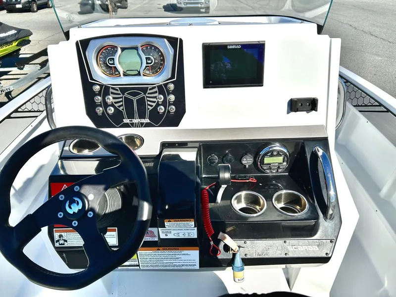 Slide: The Image of 2020 Scarab 195 Open ID boat dashboard with steering wheel and control panel. - 20