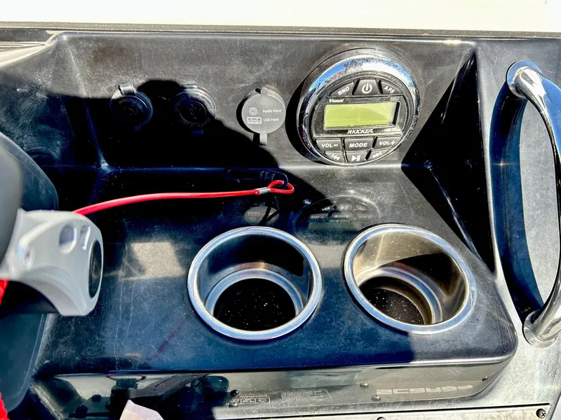 Slide: The Image of 2020 Scarab 195 Open ID dashboard with cup holders and control panel. - 23