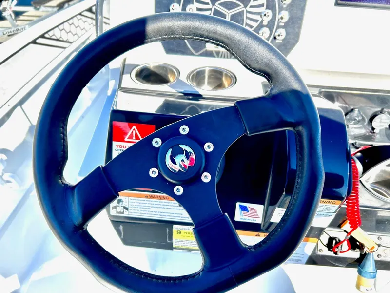 Slide: The Image of Steering wheel of 2020 Scarab 195 Open ID boat with control panel. - 24