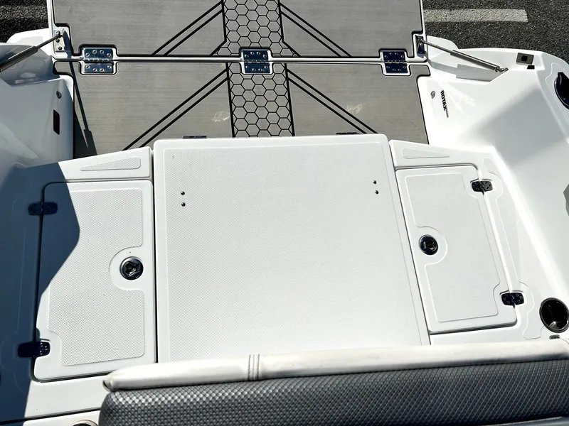 Slide: The Image of 2020 Scarab 195 Open ID boat deck with storage compartments and textured flooring. - 25