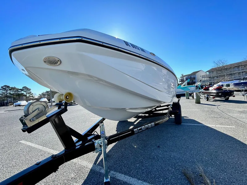 Slide: The Image of 2020 Scarab 195 Open ID boat on a trailer in a parking lot. - 3