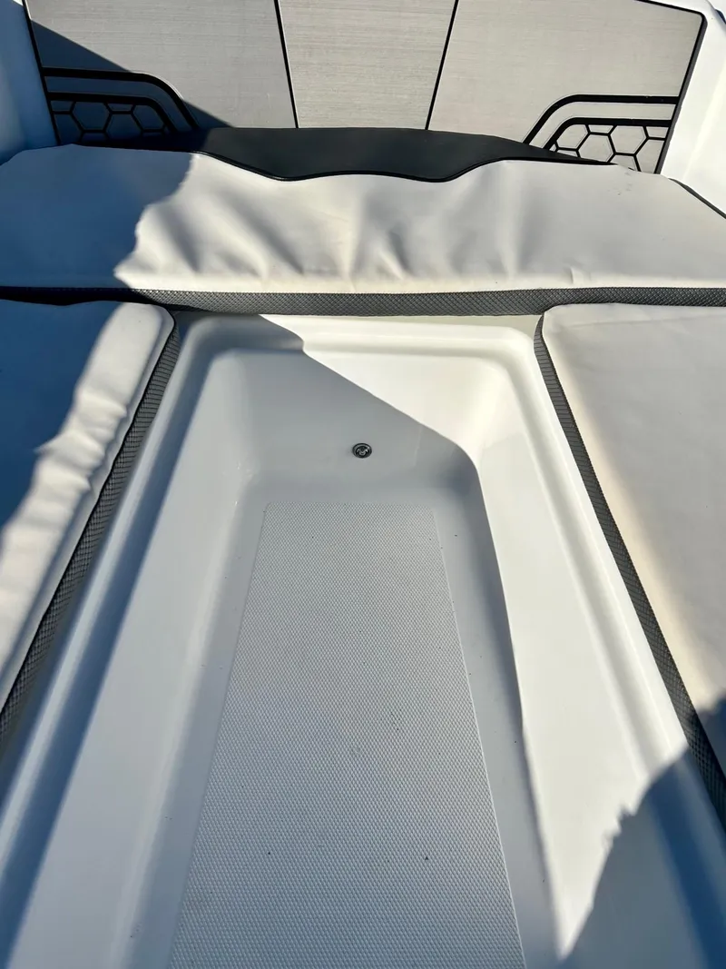 Slide: The Image of 2020 Scarab 195 Open ID boat interior with cushioned seating and storage area. - 30