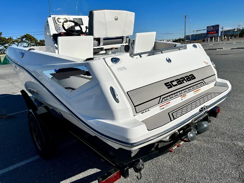 Slide: The Image of 2020 Scarab 195 Open ID boat on trailer in parking lot. - 37
