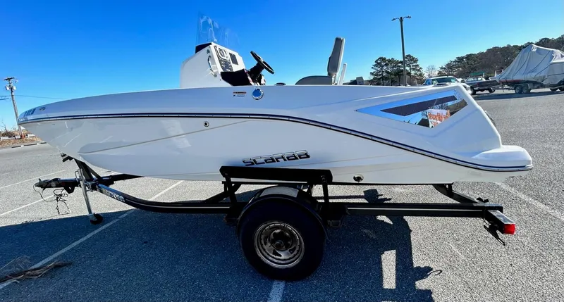 Slide: The Image of 2020 Scarab 195 Open ID boat on trailer in parking lot. - 5