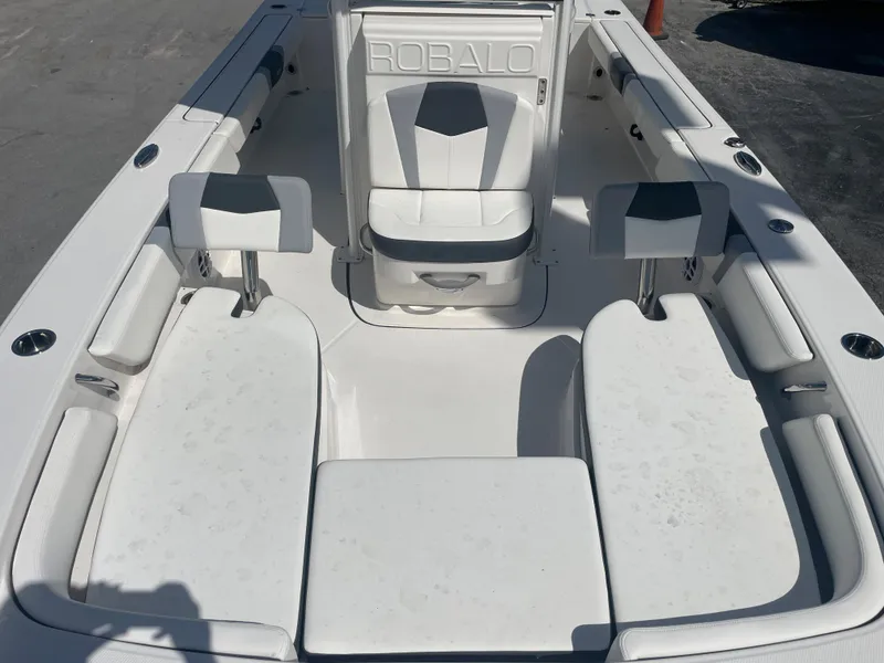 Slide: The Image of 2023 Robalo 246 Cayman boat interior with white seating and sleek design. - 12