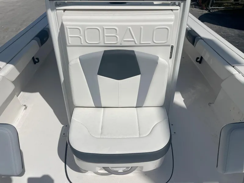 Slide: The Image of 2023 Robalo 246 Cayman boat seat with logo, white and gray design. - 13
